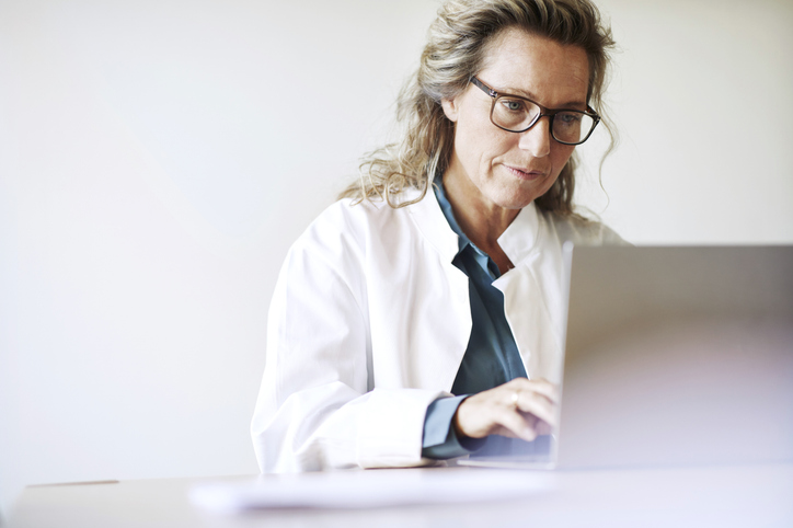 Female doctor using laptop